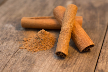 cinnamon sticks on the wooden table and cinnamon powder