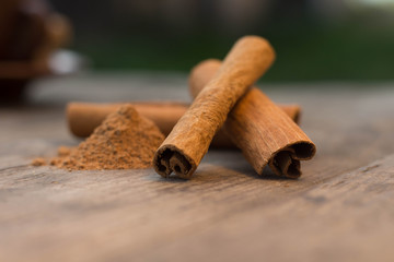 cinnamon sticks on the wooden table and cinnamon powder