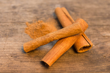 cinnamon sticks on the wooden table and cinnamon powder