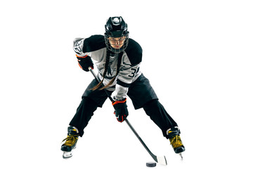Naklejka premium Young female hockey player with the stick isolated on white background. Sportswoman in action wearing equipment attacking for the goal or score. Concept of sport, healthy lifestyle, motion, movement.
