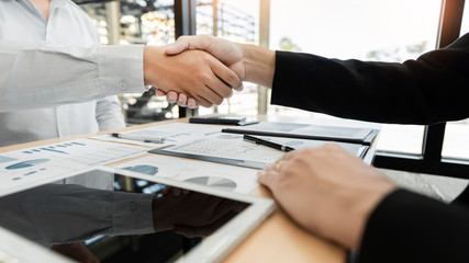 Business Meeting agreement Handshake concept, Hand holding after finishing up dealing project or bargain success at negotiation over office background.