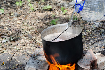 cooked soup in a cauldron on open fire