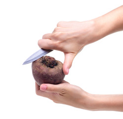 Red beet vegetable knife in hand on white background isolation