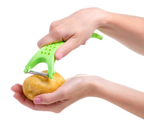 potatoes and peeler in hand on white background isolation