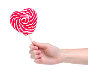 Candy lollipop heart in hand on white background isolation