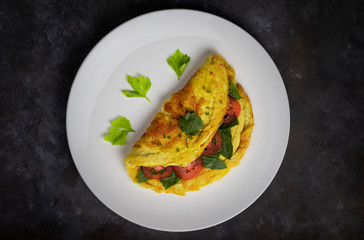 Omelette with tomatoes slide, coriander and scallion.