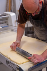 confectioner works the puff pastry dough, artisan, gourmet