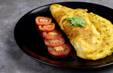 Omelette with tomatoes slide, coriander and scallion.
