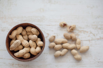 peanuts in the shell in a wooden bowl
