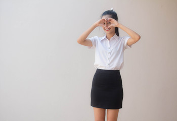 Portrait of thai adult student university uniform beautiful girl give heart