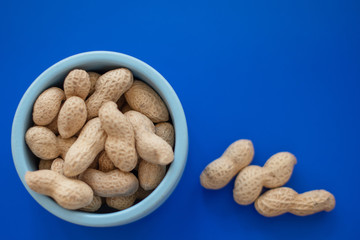 peanuts in the shell in a blue bowl