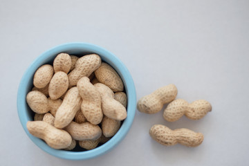 peanuts in the shell in a blue bowl