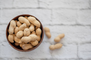peanuts in the shell in a wooden bowl
