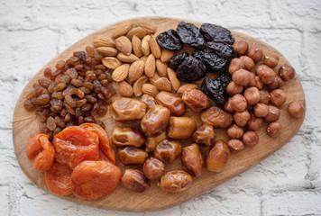 assorted dried fruits on a wooden board