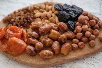 assorted dried fruits on a wooden board