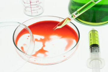 Syringe with the blood contained within and Erlenmeyer flask chemical packing as well, and Glass...