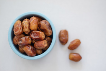 dried dates in a blue bowl