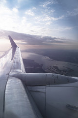 Fototapeta premium View from the airplane window on the river below. Tourist route to warm countries. The theme of the travel agency. Stock photo