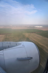 View from the plane window to the trees and meadows. Tourist route to warm countries. The theme of the travel agency. Stock photos