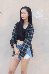 Fototapeta premium Portrait of thai china adult beautiful girl black shirt blue jeans relax and smile