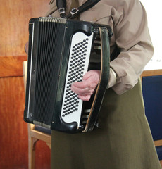 A Lady Playing a Traditional Piano Accordion.