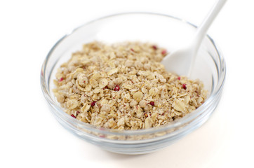 Muesli in a glass bowl on a white background