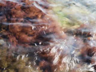 Sea water flowing over the rocks