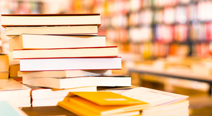 different books lying on table in library