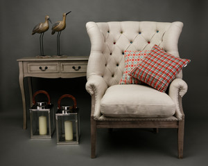 Armchair and 2 cushions  with side table on grey background