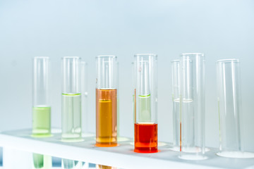 Multiple test tubes packed with chemicals, close-ups, background