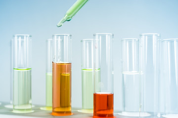 Science experiment equipment. Pipettes take samples to a test tube containing chemicals.