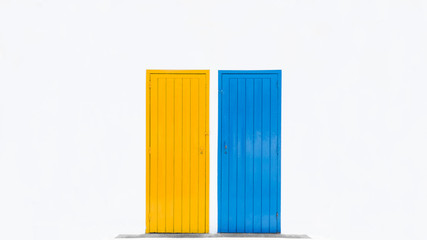 Yellow and blue doors on a white wall