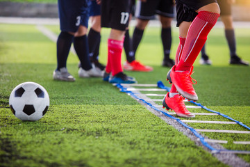 Soccer player Jogging and jump between marker for football training. Ladder Drills Exercises for Football Soccer team.