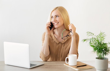 Happy Secretary Calling On Smartphone In Office
