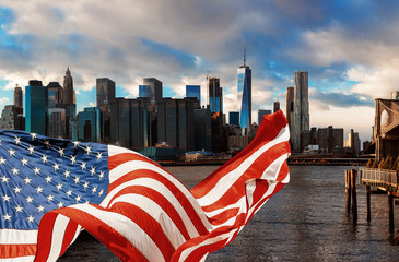 Brooklyn Bridge in New York City Manhattan and American flag flying