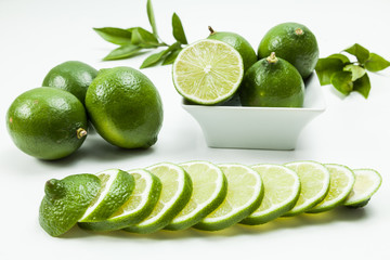 Green lemon tahiti or Citrus latifolia, isolated on  neutral background