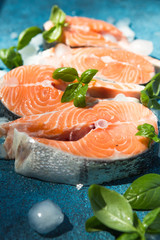 Salmon. Raw Trout Red Fish Steak served with Herbs and Lemon and olive oil on slate. Cooking Salmon, sea food. Healthy eating concept.