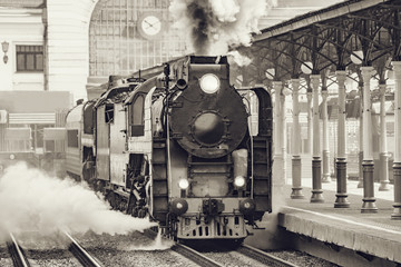 Retro train departs from railway station building. Moscow.