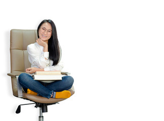 The woman wore a white shirt, wearing glasses on the chair, yellow socks, holding a pencil and a book. She was smiling.