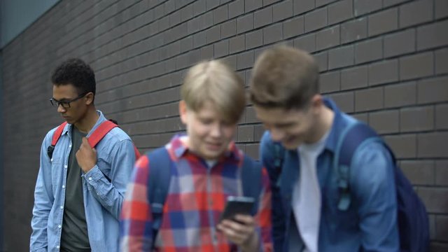 Two classmates posting offensive video about african american boy, cyberbullying