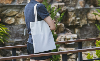 woman carry bag on nature background in save earth concept or say no plastic bag.