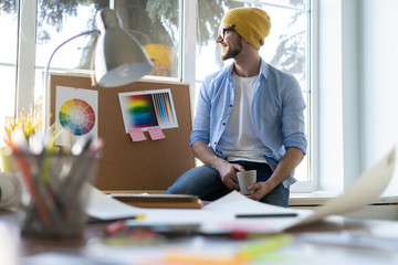 young designer taking a break at office.