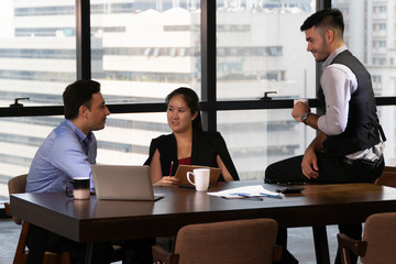 Group of young business people discussing in modern coworking space. Teamwork Cooperation . meeting .  communicating together. Working in the Office .Partnership . entrepreneurs