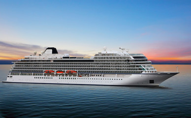 Luxury cruise ship sailing from port on sunset 