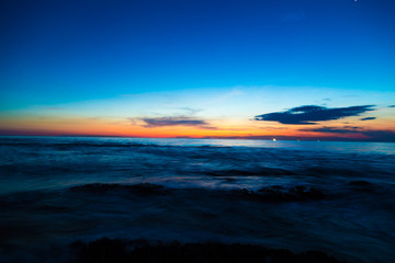 Fototapeta na wymiar Silhouette scene of sea beach sunset with colorful sky
