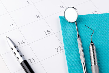 Reminder Dentist appointment in calendar and professional dentistry instruments and dental...