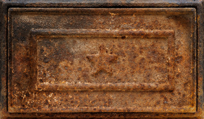 Star shape relief on rusty cast-iron panel