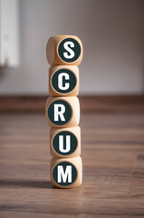 Tower made of cubes and dice with word SCRUM