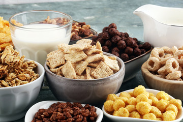 Cereal. Bowls of various cereals and milk for breakfast. Muesli with kids cereals.