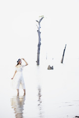 Naklejka premium Lonely girl standing at the lake.